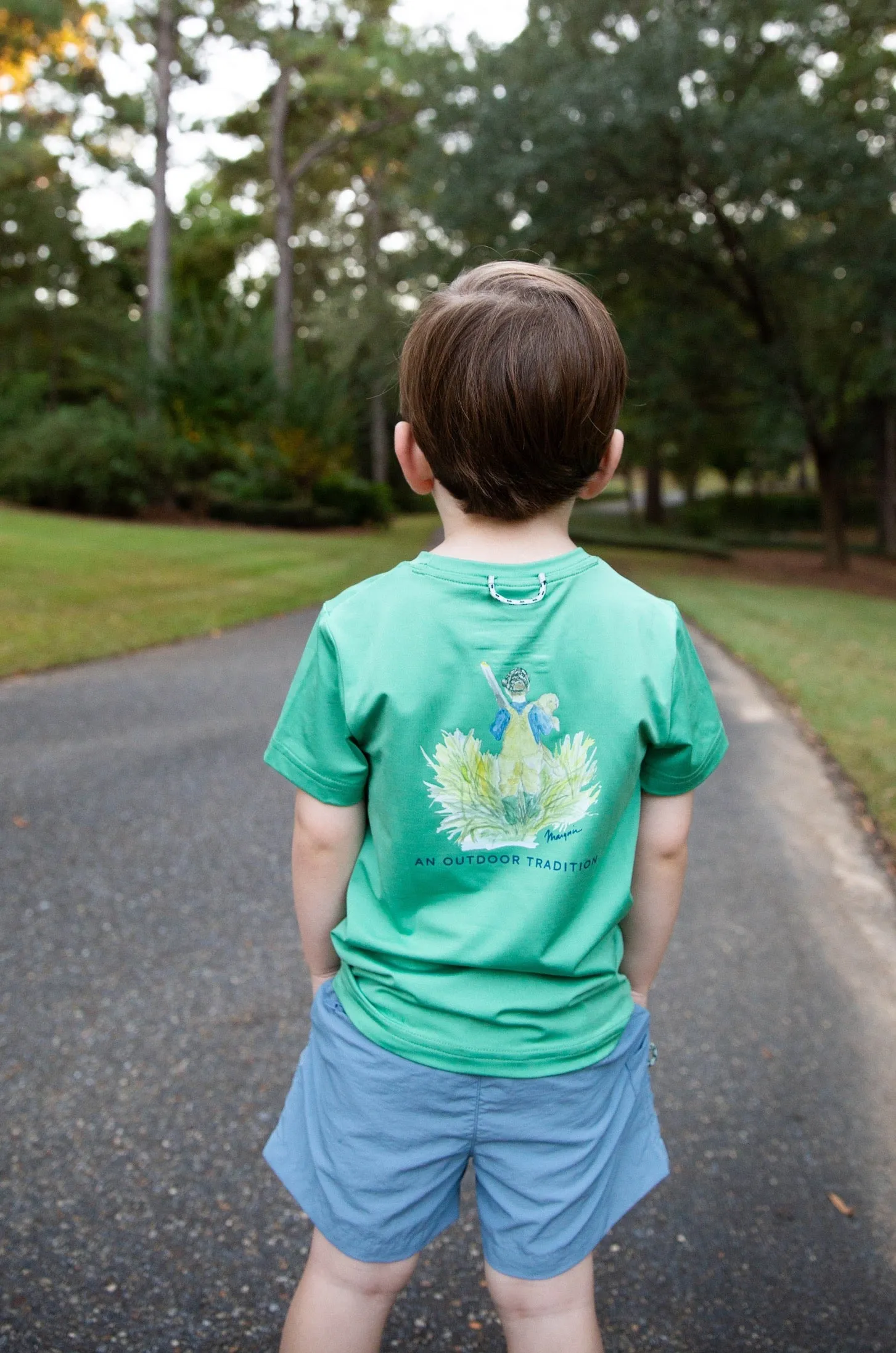 Kids Pro Performance Short Sleeve Fishing T-shirt in Green Spruce Boy and his Lab Puppy